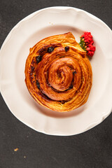 Raisin bun sweet pastry dessert puff pastry fresh delicious gourmet food background on the table rustic food top view copy space