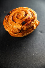 Raisin bun sweet pastry dessert puff pastry fresh delicious gourmet food background on the table rustic food top view copy space