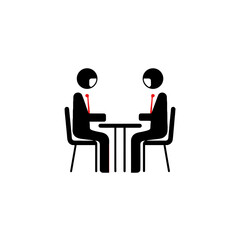 Fototapeta premium Two individuals in suits engaged in a meeting at a small table.