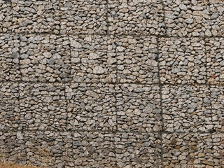 Gabion wall, a type of retaining wall consisting of wire baskets filled with stones