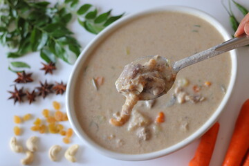 Kerala style mutton stew in a white bowl, made with tender mutton, carrots, coconut milk, curry leaves, and spices