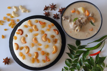 Kerala style mutton stew paired with vattayappam, a steamed rice cake topped with raisins and cashews