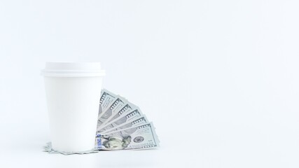 Coffee Cup with Money on White Background. Business Concept, Investment and Expenses.