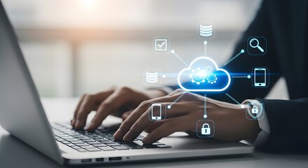 Hands typing on laptop with glowing cloud technology icons and digital network connections