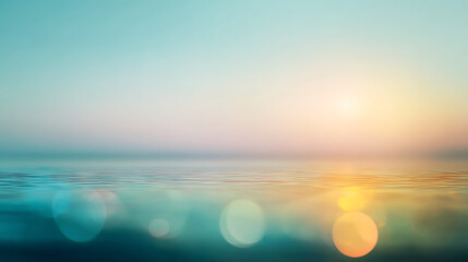 Calm ocean surface reflecting soft pastel sunset light with bokeh water sunrise