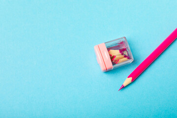 Pencil sharpener on bright colored background. Pencil and pencil shavings. Stationery. School...