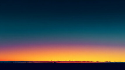 Fototapeta premium Deep blue sky fades to vibrant orange and purple over distant mountains at twilight sunset gradient