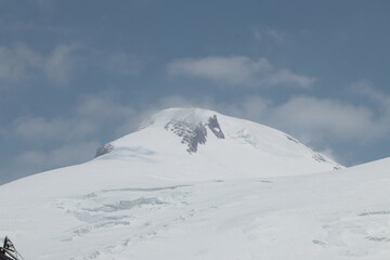 The western summit of Elbrus in the clouds on a sunny summer day