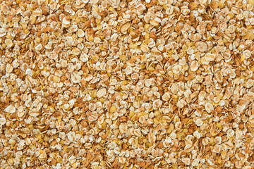 Raw multigrain oatmeal, walnuts, millet, wheat flakes background or texture. Mix flakes. Texture...