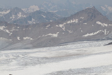 Azau glacier on the slopes of Elbrus on a sunny day in early August