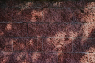 Red brick background with sun glare