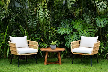 Obraz premium Outdoor Living Space with Rattan Chairs and Lush Tropical Greenery Inviting Relaxation and Serenity