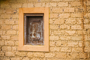 adobe brick wall with rustic window