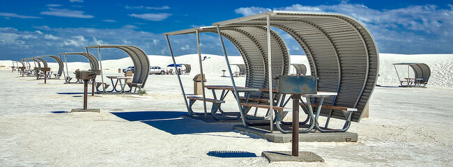 The portable picnic shelters look like sails scattered across the ocean. Blocking the wind and sand, while providing some much need shade from the harsh sunlight. White Sands National Park