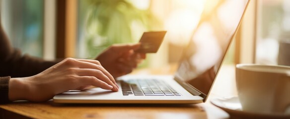 The laptop and credit card showcasing online shopping in a cozy workspace.