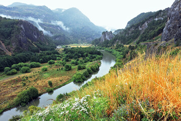 The river bends between the hills
