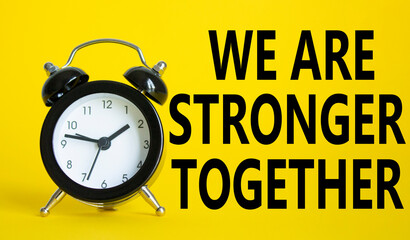 We are stronger together symbol. Beautiful yellow background with alarm clock with words We are stronger together. Business and We are stronger together concept. Copy space.