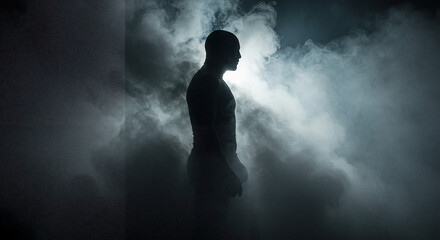 Silhouette of a Muscular Man Standing in Ethereal Smoke and Dramatic Backlighting.