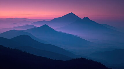 Fototapeta premium Mountain ranges at dawn, bathed in muted colors.