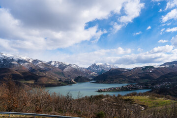 Scenic mountain lake in a snow-capped valley under a cloudy sky