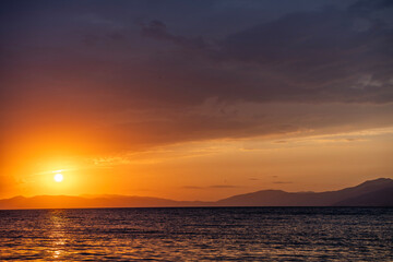 Fototapeta premium Beautiful sunset over the lake and mountains. 
