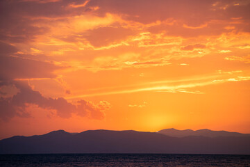 Beautiful sunset over the lake and mountains.
