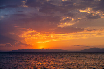 Beautiful sunset over the lake and mountains.