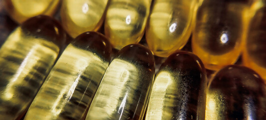 Fish oil in yellow tablets on a gray background