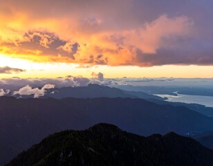 Obraz premium Mountain sunrise, vibrant clouds, valley below