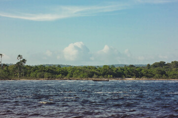 View of a boat with tourists and the mountains in the lagoon of Canaima National Park in Venezuela