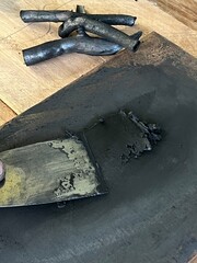 Charcoal and spatula with printmaking ink on a wooden