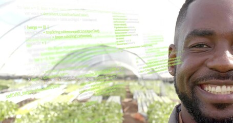 Greenhouse grower smiling as programming code fading sparking agritech data overlaying seedlings