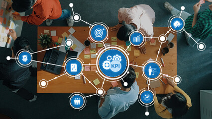 Dynamic Business Strategy Meeting with Focus on Key Performance Indicators and Collaborative Planning with Visual Tools and Metrics on Meeting Table. Amity