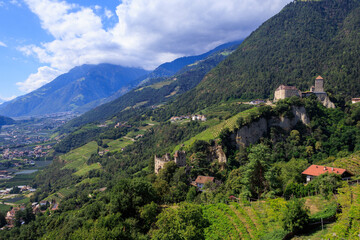 Fototapeta premium Panorama with Tyrol Castle (Schloss Tirol), Schloss Brunnenburg and vineyards in the mountains of Tirol (Dorf Tirol) in South Tyrol, Italy