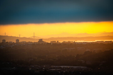 Naklejka premium sunset over edinburgh over the firth of forth, view from calton hill, edinburgh, scotland, forth of forth bridges