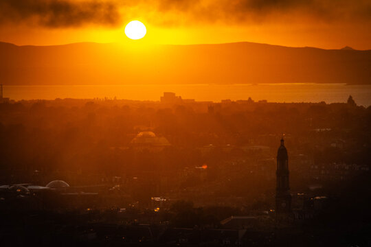 sunset over edinburgh over the firth of forth, view from calton hill, edinburgh, scotland