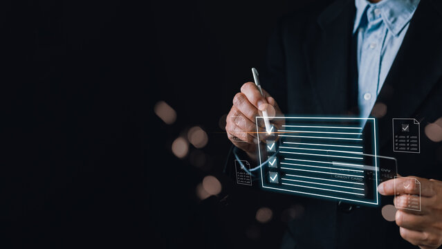A businessman uses a stylus on a digital checklist interface with glowing blue lines, symbolizing technology driven task management,efficiency,organization,and modern productivity solutions.