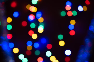 Colorful defocused Christmas lights on dark background
