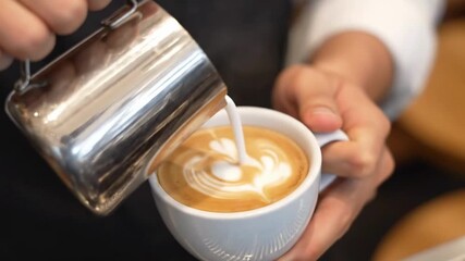 A Professional Barista Creating Beautiful Latte Art by Pouring Steamed Milk into a Cup of Coffee - Powered by Adobe