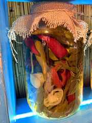 Jar of pickled peppers with burlap cover