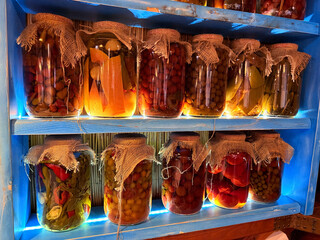 Shelves with homemade preserves in jars