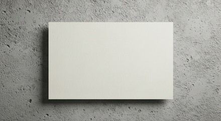 Blank White Canvas on Textured Concrete Wall Background.