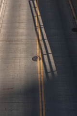manhole cover in the middle of the street with dramatic lighting 
