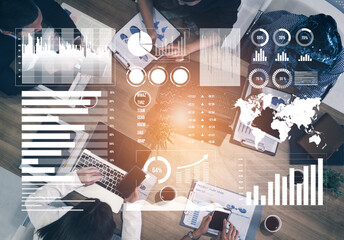 A diverse business team collaborates over data analysis and charts in a modern workspace, aiming to devise effective strategies for future projects. Impute