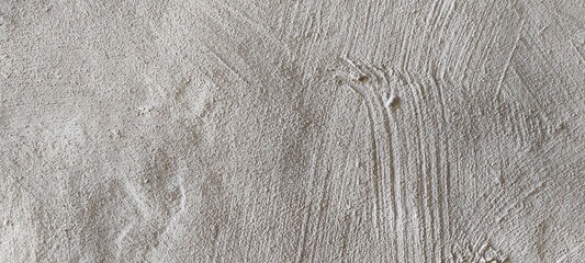 Texture of Wet Plaster on a Wall Showing Uneven Surface Patterns and Subtle Shades of Gray