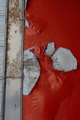 red peeling paint on the ceiling 