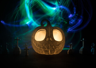 Halloween concept. Creepy silhouette in the dark corridor with pumpkin head. Toned light with fog on background.
