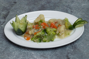 Stir Fry Chinese Vegetable with broccoli, carrots, and a savory sauce on a white plate top view of Asian cuisine