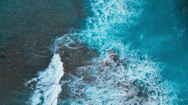 Turquoise Ocean Waves Crashing on Coral Reef, Top View