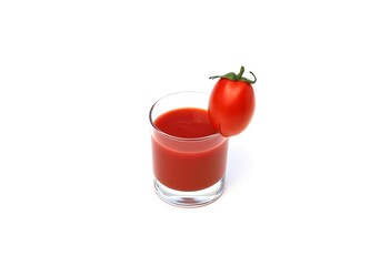 A glass of tomato juice. With a small tomato on the edge.